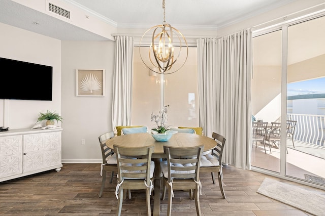 dining room featuring crown molding, hardwood / wood-style flooring, and a notable chandelier