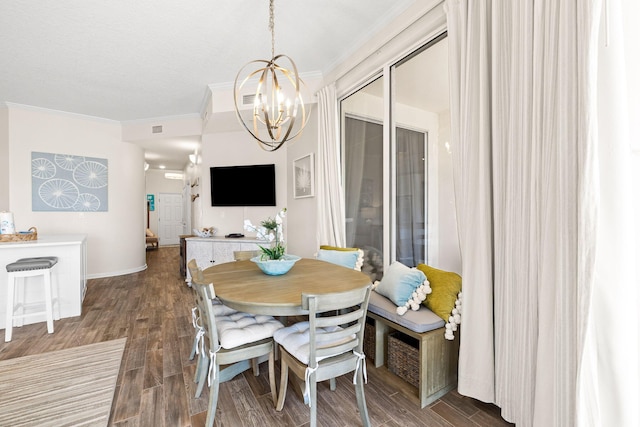 dining room featuring ornamental molding and a notable chandelier