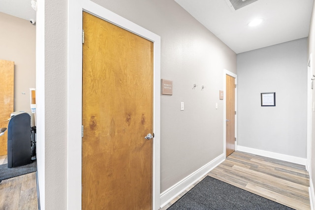 hall with light hardwood / wood-style flooring