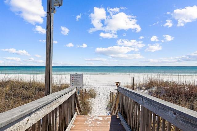 view of property's community featuring a beach view and a water view