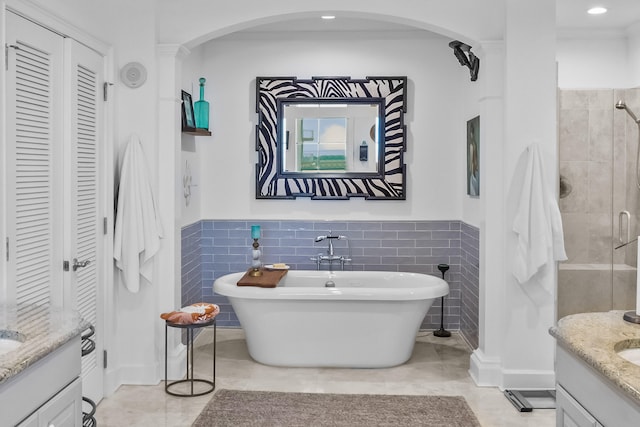 bathroom with vanity, tile patterned flooring, and tile walls