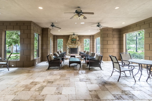 view of patio / terrace featuring an outdoor living space with a fireplace and ceiling fan