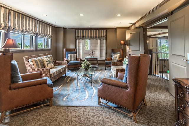 living room featuring ornamental molding, a wealth of natural light, and dark carpet