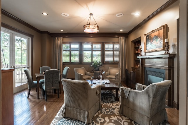 living area featuring crown molding and wood-type flooring