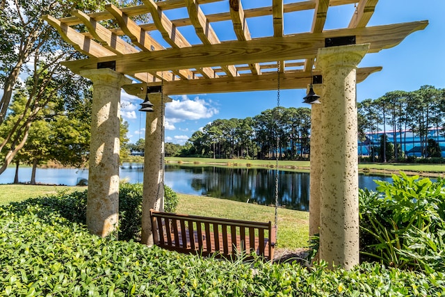 exterior space with a water view and a pergola