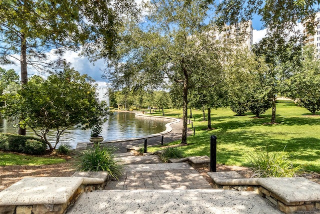 view of community featuring a water view and a yard