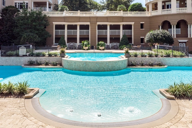 view of swimming pool featuring pool water feature