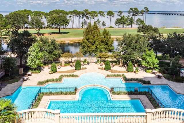 view of swimming pool featuring a water view