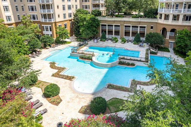 view of swimming pool with a hot tub