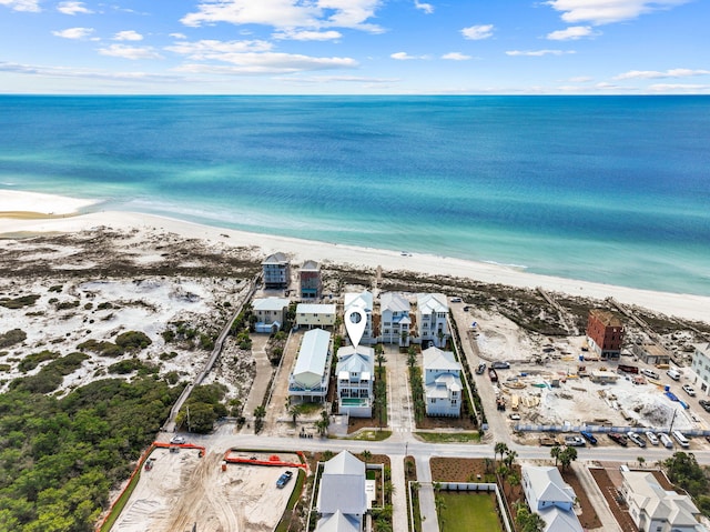 drone / aerial view with a water view and a beach view