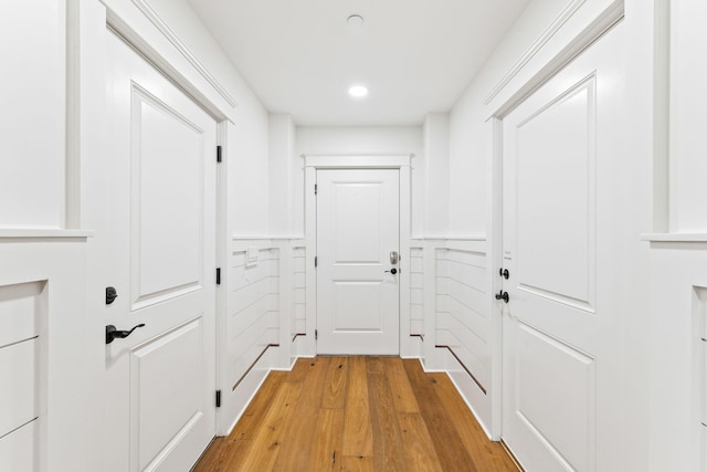 hallway with light hardwood / wood-style floors