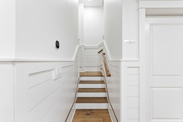 stairway featuring wood-type flooring