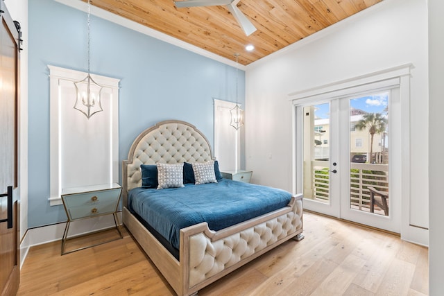 bedroom featuring wooden ceiling, light hardwood / wood-style flooring, access to exterior, and a barn door