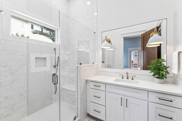 bathroom featuring an enclosed shower and vanity