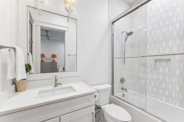 full bathroom featuring combined bath / shower with glass door, toilet, and large vanity