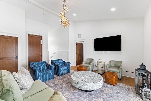 living room featuring beam ceiling, high vaulted ceiling, and hardwood / wood-style floors