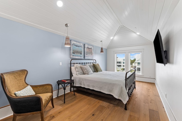 bedroom featuring wooden ceiling, light hardwood / wood-style flooring, and lofted ceiling