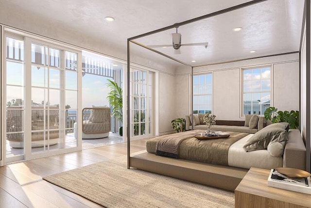 bedroom featuring light hardwood / wood-style flooring, ceiling fan, and access to outside