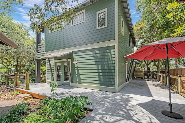 rear view of house featuring french doors and a wooden deck