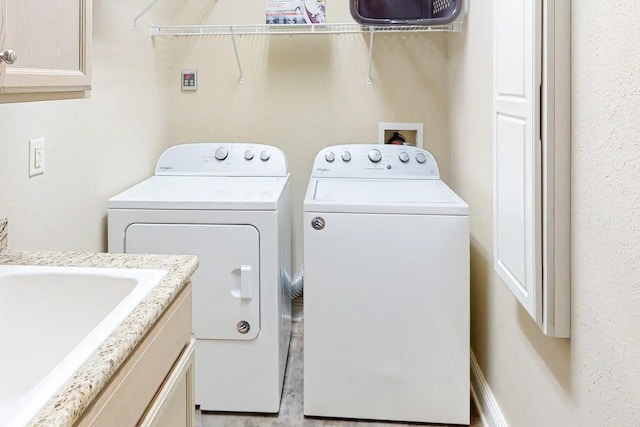 laundry area featuring washer hookup, sink, and washer and dryer