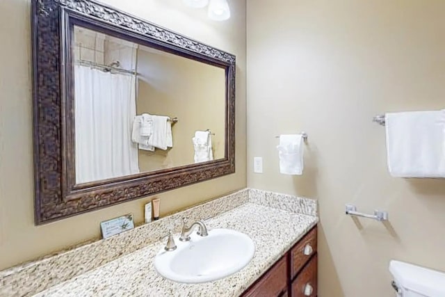 bathroom featuring toilet and vanity