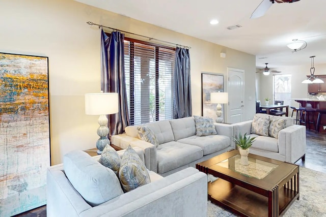 living room featuring ceiling fan and plenty of natural light