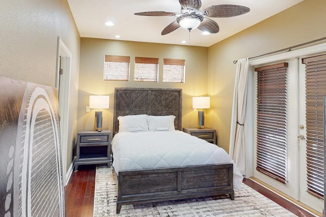 bedroom with dark hardwood / wood-style flooring and ceiling fan