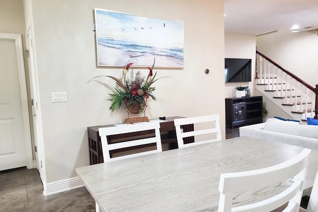 dining space with dark tile flooring