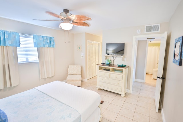 tiled bedroom with a closet and ceiling fan