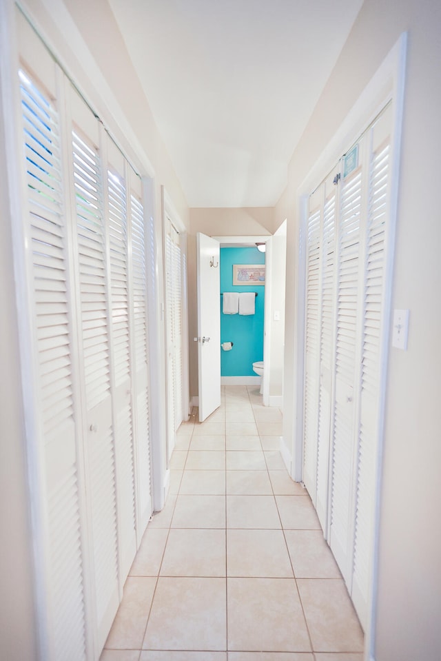 hallway with light tile floors and a wealth of natural light