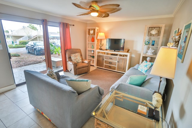 living room with crown molding, ceiling fan, and light tile floors