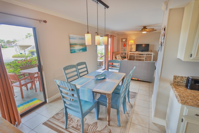 tiled dining room with rail lighting, ceiling fan, and ornamental molding