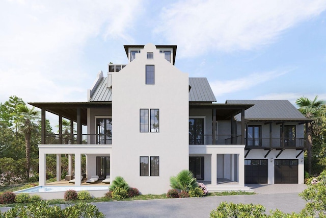 exterior space featuring a patio, a garage, and a balcony