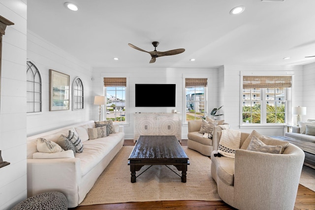 living room with hardwood / wood-style floors, plenty of natural light, and ceiling fan