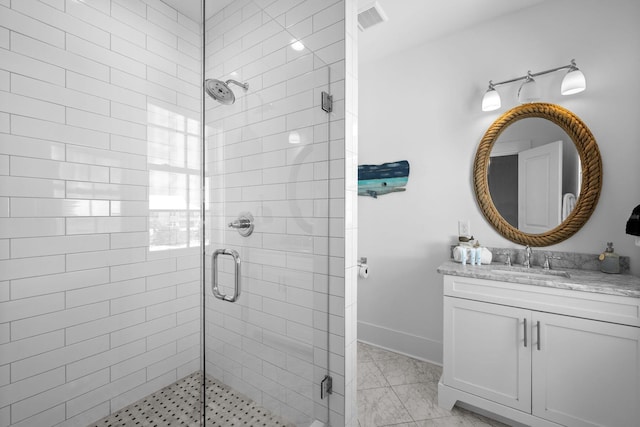 bathroom with vanity with extensive cabinet space, tile floors, and a shower with shower door