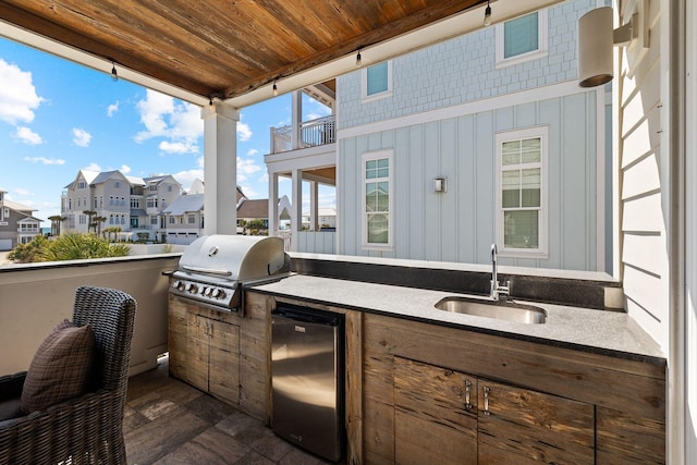 view of patio / terrace featuring sink, a balcony, an outdoor kitchen, and grilling area