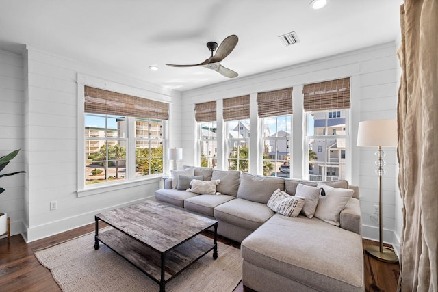 living room featuring ceiling fan and dark hardwood / wood-style flooring