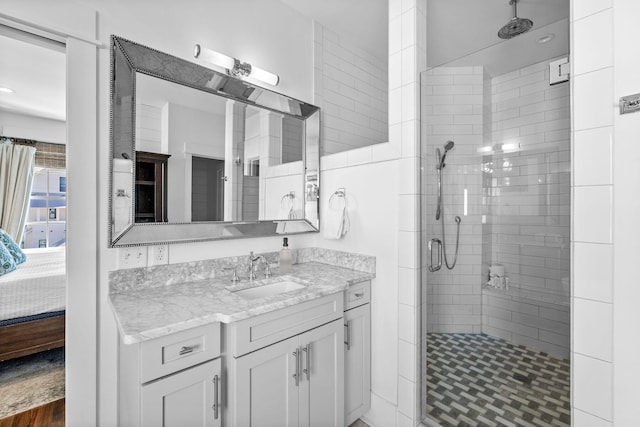 bathroom featuring wood-type flooring, vanity, and a shower with shower door