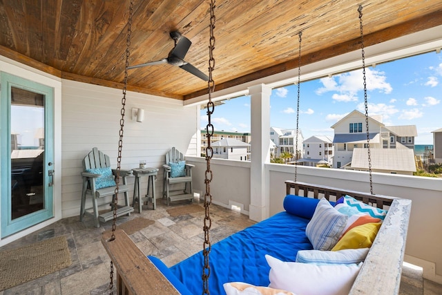 sunroom / solarium with wooden ceiling and ceiling fan