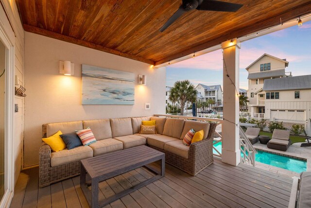 deck at dusk featuring ceiling fan and an outdoor hangout area