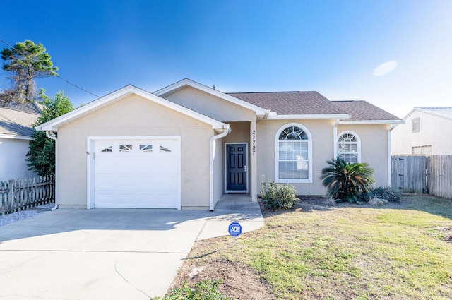 ranch-style house featuring a front lawn and a garage