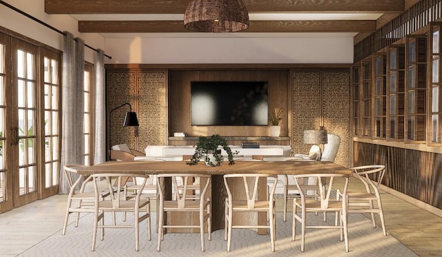 interior space with beamed ceiling, a wealth of natural light, french doors, and light wood-type flooring