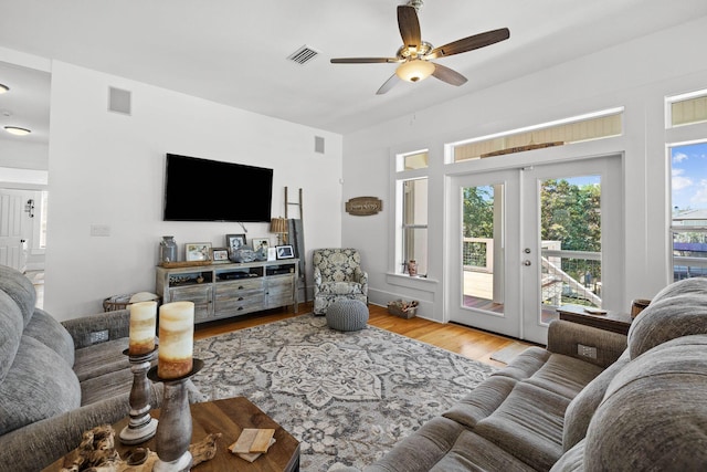 living room featuring french doors, light hardwood / wood-style flooring, and ceiling fan