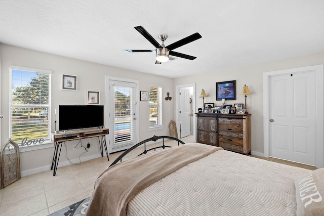 tiled bedroom featuring ceiling fan and access to exterior