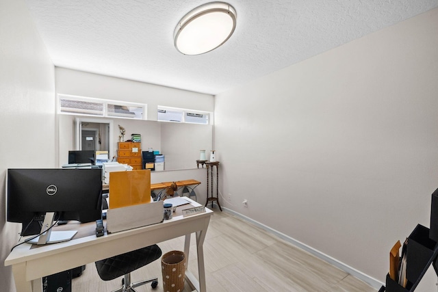 office space featuring a textured ceiling and light tile flooring