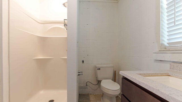 bathroom featuring a shower, vanity, toilet, and tile floors