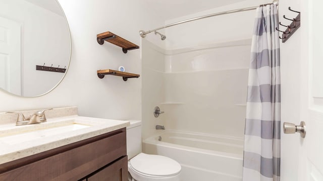 full bathroom featuring vanity with extensive cabinet space, shower / tub combo, and toilet