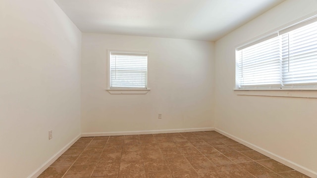 empty room with dark tile flooring