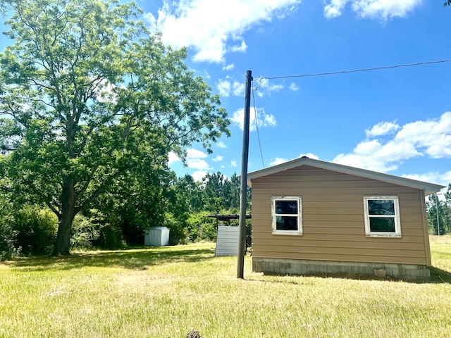 view of property exterior featuring a storage unit and a yard