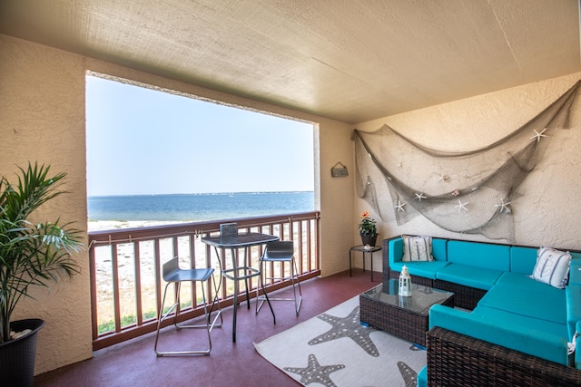 balcony with an outdoor living space and a water view